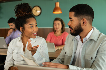 black business woman sharing thoughts and ideas with the team in workstation. .
