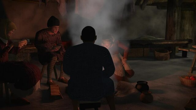 family gathered around fire inside medieval farm