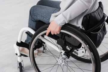 Obraz premium Cropped view of woman in wheelchair at home
