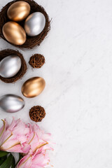 Design concept of Golden and silver Easter eggs in the nest with pink lily flower.