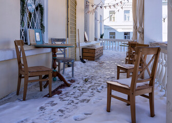 tables and chairs in a open air restaurant in winter