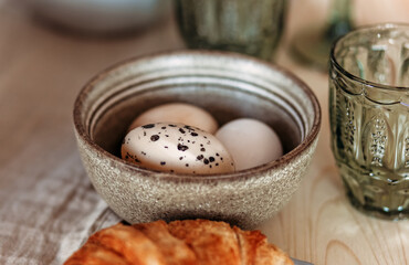 Top view close-up of chicken eggs in a white plate on a wooden table. Healthy food and natural cuisine concept
