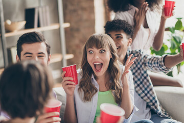 Portrait of attractive overjoyed funky cheerful best friends spending time having fun drinking lager in house brick loft style indoors