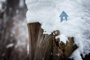 Conceptual paper houses in snow forest