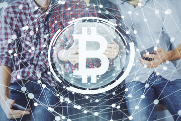 Double exposure of crypto theme drawing and man and woman working together holding and using a...