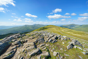 Fototapeta na wymiar Distant views of the mountain summits of Meall Garbh, Ben Lawers, Beinn Ghlas and Meall Corranaich from the top of Meall na Aighean with Glen Lyon below in the Scottish Highlands, UK landscapes.
