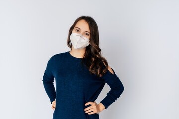 beautiful young woman wearing an anti viurs protection ffp2-mask to prevent from corona covid-19 and sars cov 2 infection white background copy space