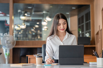 Fototapeta premium Portrait of businesswoman working with computer device in the office room.
