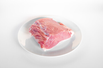 sliced raw pork meat isolated on white background ready for cooking. a piece of pork