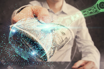 Double exposure of technology drawing hologram and us dollars bills and man hands. Data concept