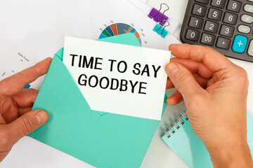 The businessman takes out a card from the envelope with the text TIME TO SAY GOODBYE