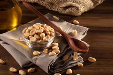 Roasted peanuts with olive oil on wooden table