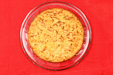 Whole cassava cake on red fabric background