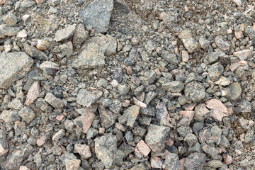 Crushed mountain stones on the ground texture background in the image
