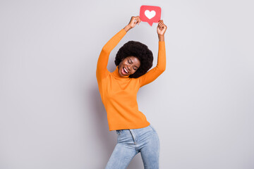 Photo portrait of black skin woman dancing holding like sign over head with two hands isolated on clear grey colored background