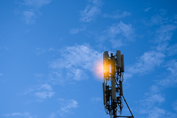 Antenna transmitting for mobile phones and smartphones with 4G and 5G internet systems. High-speed signal transmission network that supports 6G systems in the future. Copy space, blue sky with clouds