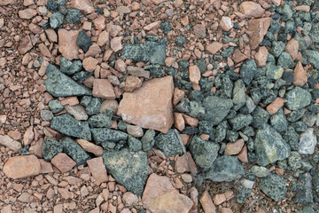 Crushed mountain stones on the ground texture background in the image