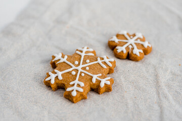 gingerbread star with sugar, spices, and vintage rolling pin on rustic, on textile linen background.