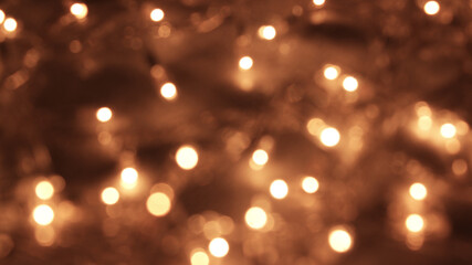 Obraz premium Golden abstract bokeh background Yellow bokeh lights redirected on blurred background. Sparkling stars bokeh are used for celebration background.