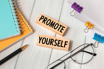 PROMOTE YOURSELF - words written on wooden blocks