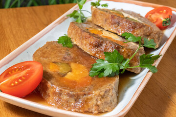 Roll of pork, eggs and vegetables