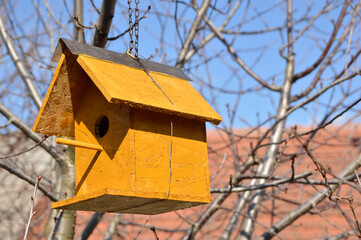 wooden bird house hanging on the tree