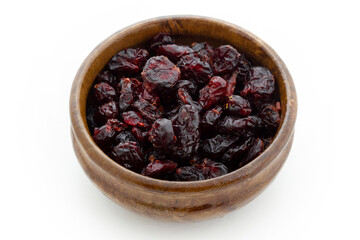 Dried blueberries in wooden bowl. Dry fruits.