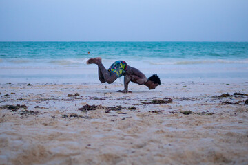 Young Attractive Muscular and Strong Athletic Black African Man at the White Sand Beach Training...