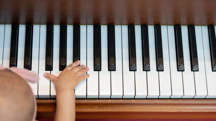Baby Girl and Adult playing with Piano Keys together