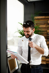 Fototapeta premium Handsome businessman writing notes. Businessman making businessplan.