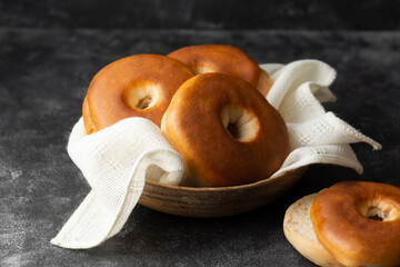 Bagels pastry buns for breakfast, sandwich or snack. Top view, dark moody background