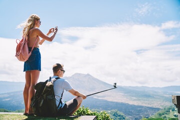 Couple taking pictures of nature while traveling