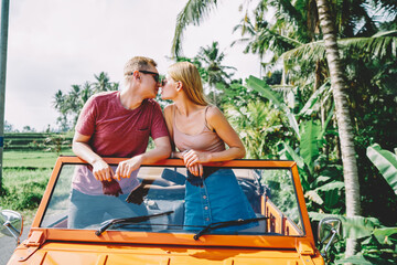 Couple kissing in car while traveling