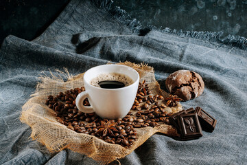 Coffee cup, coffee beans, chocolate, anise and tasty cookie