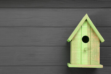 Obraz na płótnie Canvas Beautiful bird house on grey wooden table, top view. Space for text