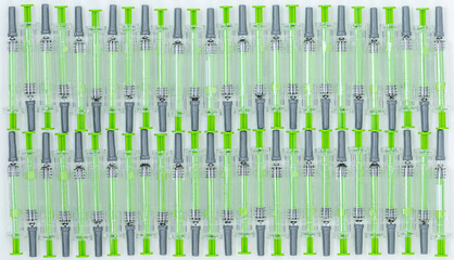 Medicine background of green syringes for vaccination and for diabetes	
