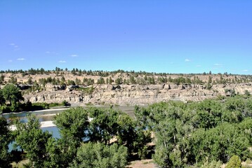 Yellowstone River reflects sandy bluffs. (Selective focus) Pompeys Pillar National Monument is a...