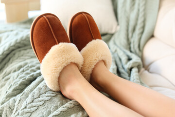 Woman wearing soft comfortable slippers at home, closeup