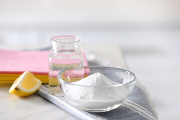 Fototapeta na wymiar Baking soda, lemon and vinegar on white marble table. Eco friendly detergents