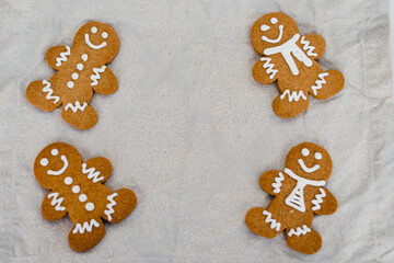 Traditional almond cookie with sugar, spices, and vintage rolling pin on rustic, on natural linen background.