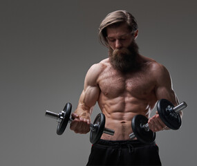 Fototapeta na wymiar Healthy lifestyle of a sportsman with bearded face and dumbells