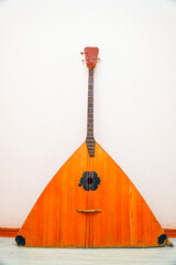 Three-string traditional national Russian musical instrument bass balalaika on white background