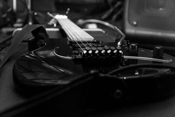 Black electric guitar with tremolo on a hard case