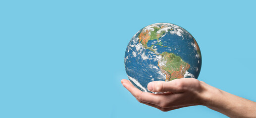 3D Earth planet globe in man, woman hand, hands on blue background. Environmental protection concept. Elements of this image furnished by NASA