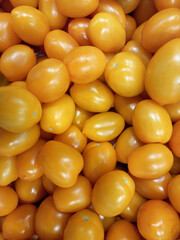 Ripe tomatoes. Yellow plum tomatoes in a box on the