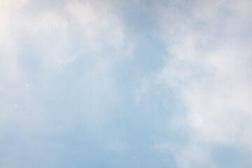 Blue sky, haze of white clouds, background.