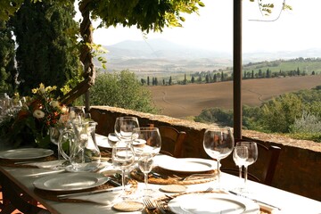 Table set for al fresco dinner on the terrace. Tuscany, Italy 