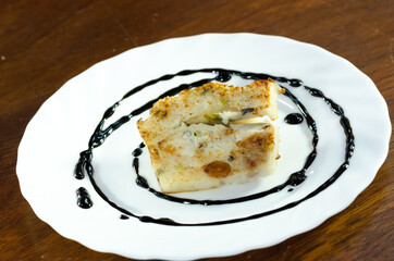 The delicious fried  turnip cake with black soy sauce. Dim Sum of turnip cake Chinese cuisine. Chinese traditional local dish radish cake. Chinese new year food.