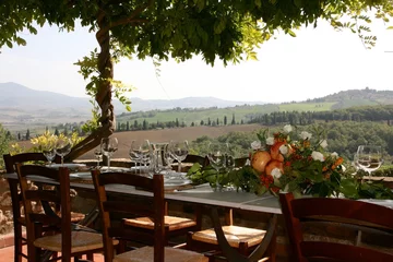 Fotobehang Table set for al fresco dinner on the terrace. Tuscany, Italy  © Julia Kostina 