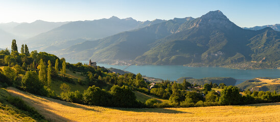 Serre-Poncon Lake in summer with Grand Morgon Peak and Savines-le-Lac village. Hautes-Alpes, Alps, France